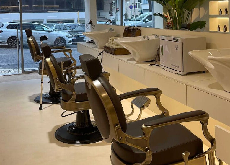 Interior of Barbieri Barbershop & SPA, Lisboa, Lisboa, PT, showing vintage barber chairs and washing stations.