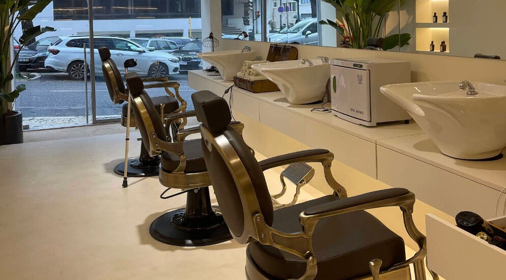 Interior of Barbieri Barbershop & SPA, Lisboa, Lisboa, PT, showing vintage barber chairs and washing stations.