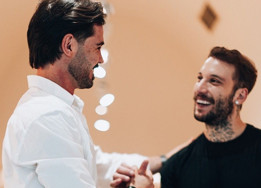 Two smiling men greet warmly at Barbieri Barbershop & SPA, Lisboa, Lisboa, PT.