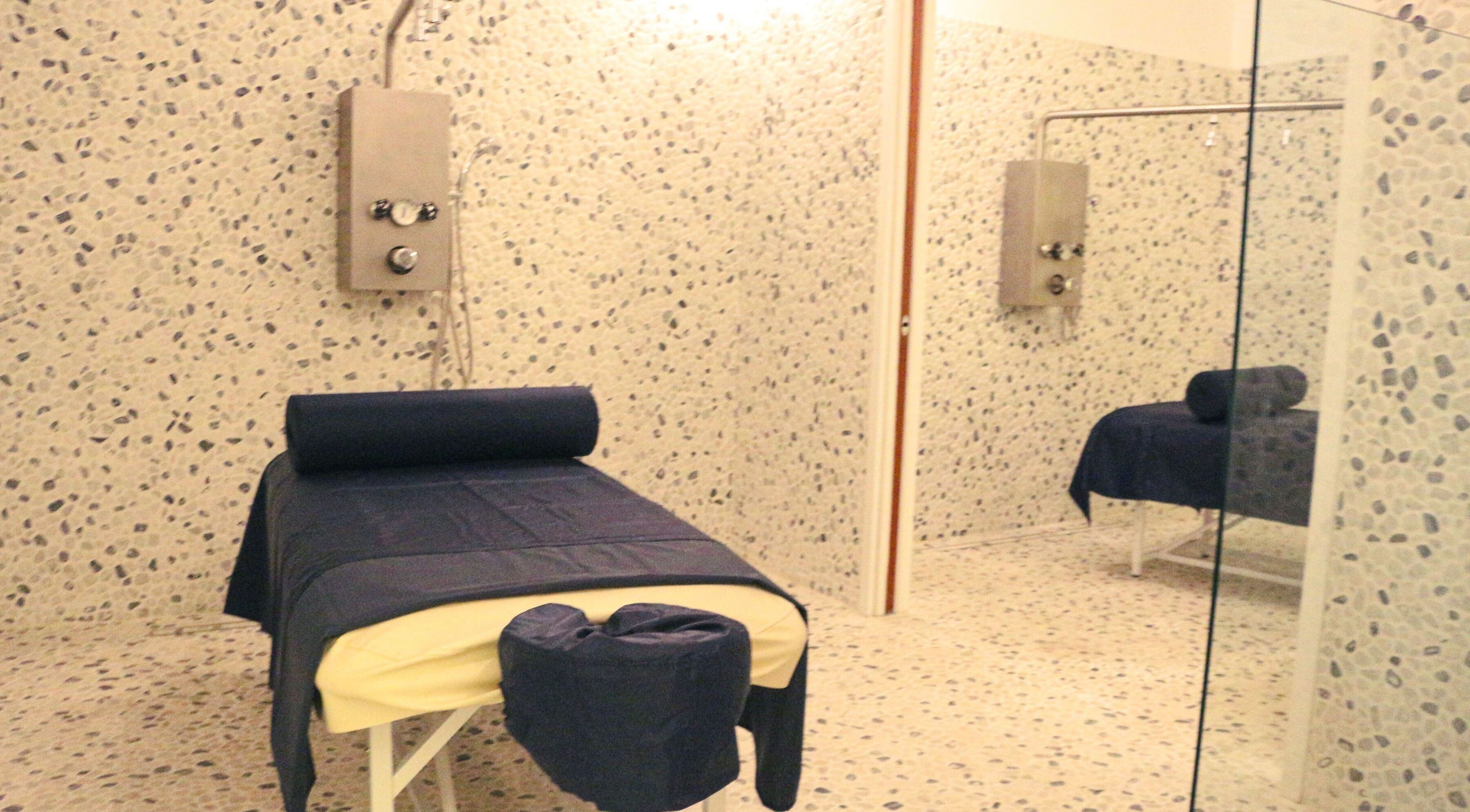 Relaxing spa room at The Lotus Center Spa, Virgin Gorda, British Virgin Islands, US with a massage table.