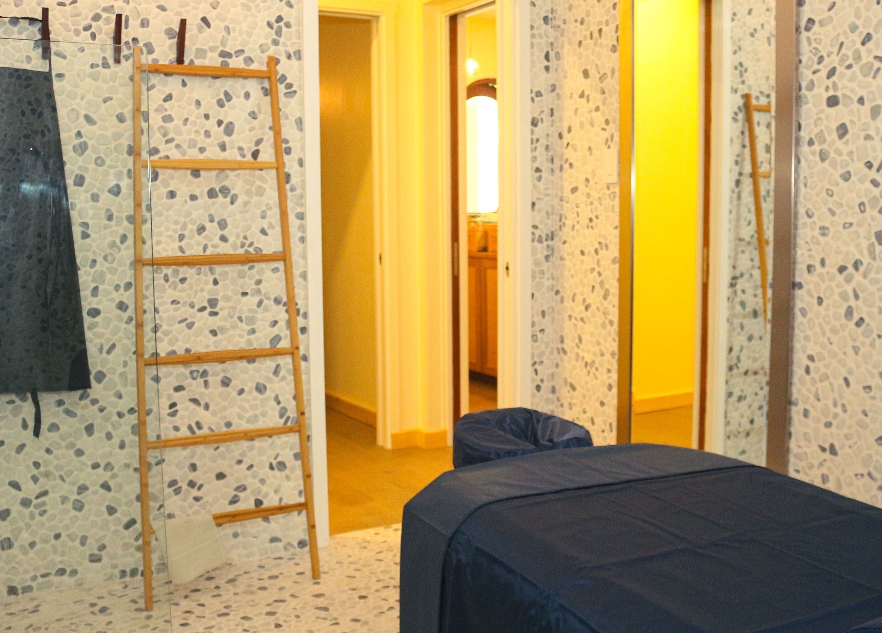Relaxing treatment room at The Lotus Center Spa, Virgin Gorda, British Virgin Islands, US with pebble walls.