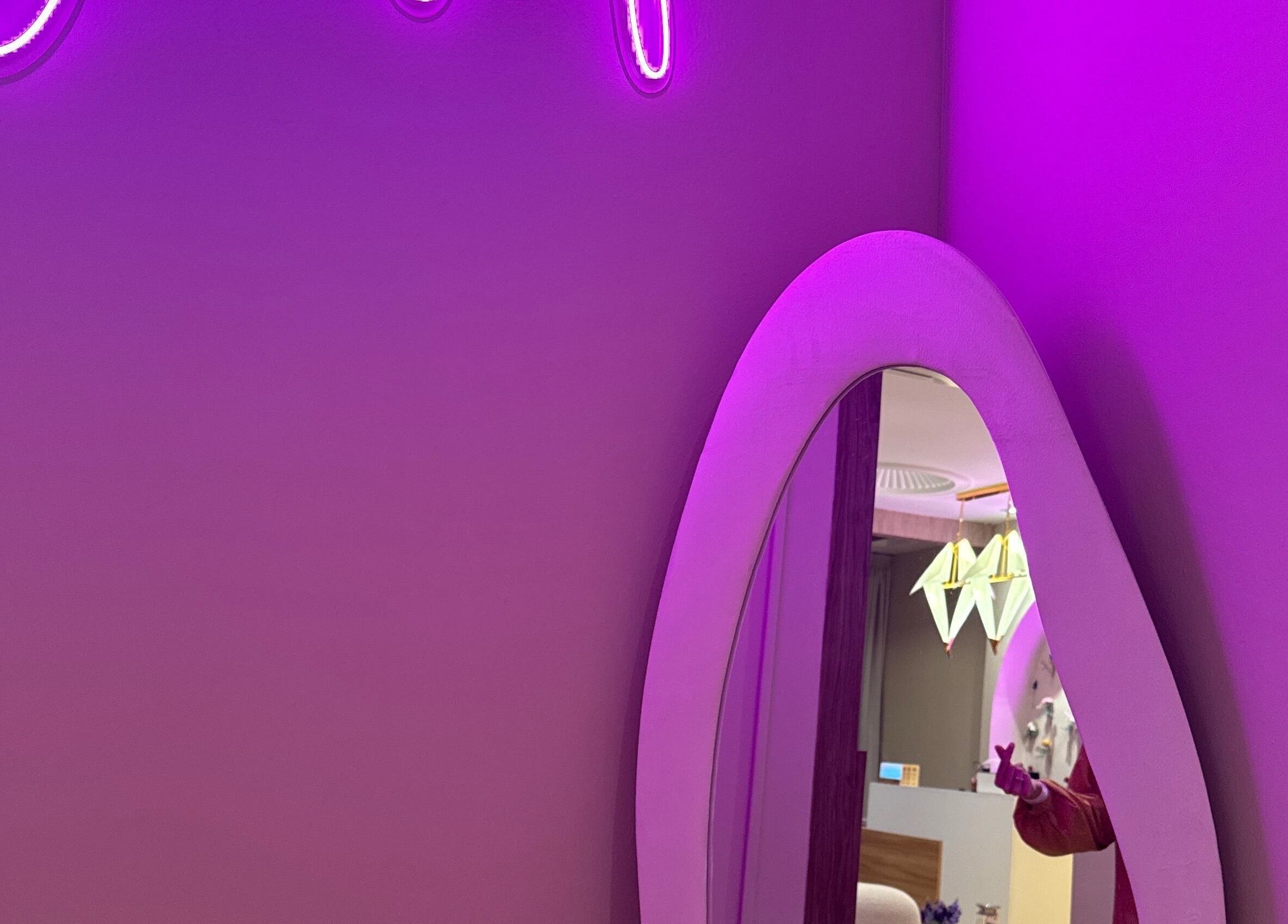 Vibrant purple neon sign and stylish mirror at Aurora Muslimah Salon & Spa Setapak, Kuala Lumpur, Wilayah Persekutuan.