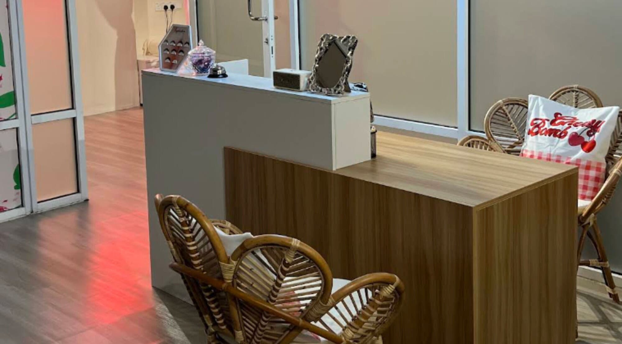 Welcoming reception area at Cherry Bomb by JJS, Petaling Jaya, Selangor, MY with wooden and wicker furniture.