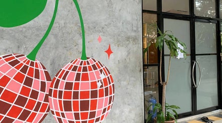 Entrance of Cherry Bomb by JJS in Petaling Jaya, Selangor, MY with modern cherry-themed artwork.