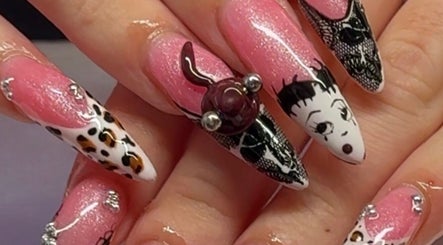 Stylish nail art at Gelz by Ellz in Napier, Hawke's Bay Region, NZ. Intricate designs with vibrant pink and white.