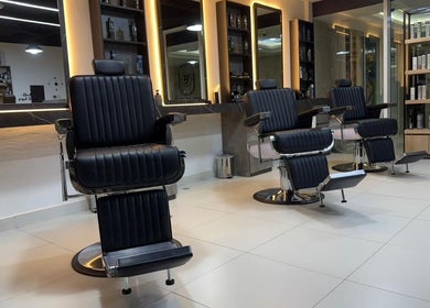 Barber chairs at Triple Nine Barber Gents Care Center in Abu Dhabi, AE, showcasing a modern and stylish interior.