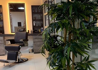 Stylish barber chair at Triple Nine Barber Gents Care Center, Abu Dhabi, AE, surrounded by modern decor.