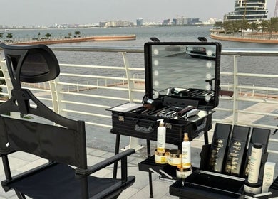 Outdoor barber setup at Triple Nine Barber Gents Care Center, Abu Dhabi with a scenic waterfront view.