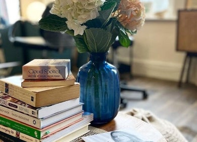 Cozy book corner at Emma-Jane Hair @ Salt & Co with a vase on a table, Dublin 2, County Dublin, IE.