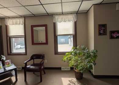 Inviting waiting area at Crystal Pavis, LMT in Cromwell, Connecticut, US with plants, chairs, and calm decor.