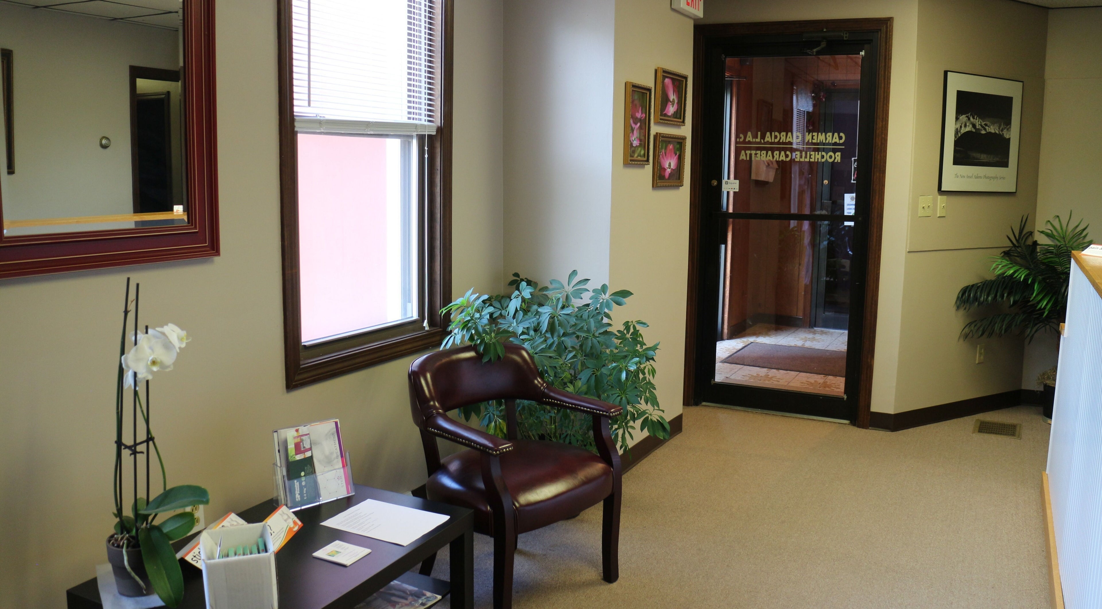Inviting lobby at Crystal Pavis, LMT in Cromwell, Connecticut, US with plants and comfortable seating.