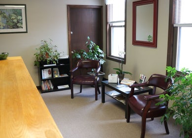 Inviting seating area at Crystal Pavis, LMT in Cromwell, Connecticut, US with plants and cozy chairs.