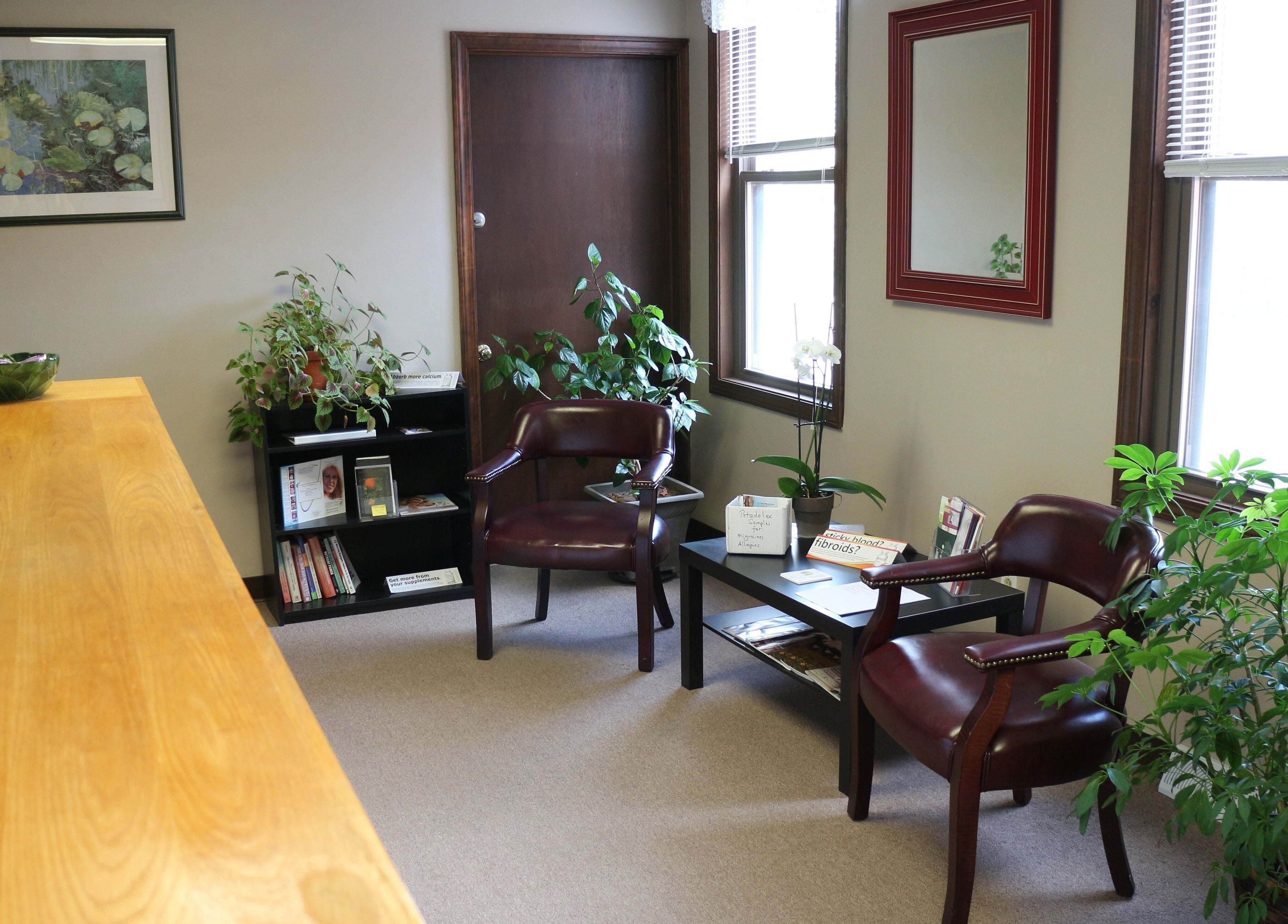 Inviting seating area at Crystal Pavis, LMT in Cromwell, Connecticut, US with plants and cozy chairs.