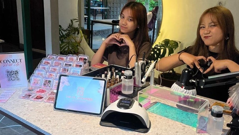 Friendly staff at Nails by Artmosphere Pop Up, Jawa Barat, ID, showcasing nail art and beauty products.