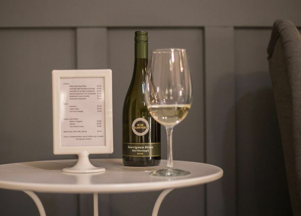 Table with wine bottle and menu at Paradise Spa and Coffee Bar, East Saint Paul, Manitoba, CA.