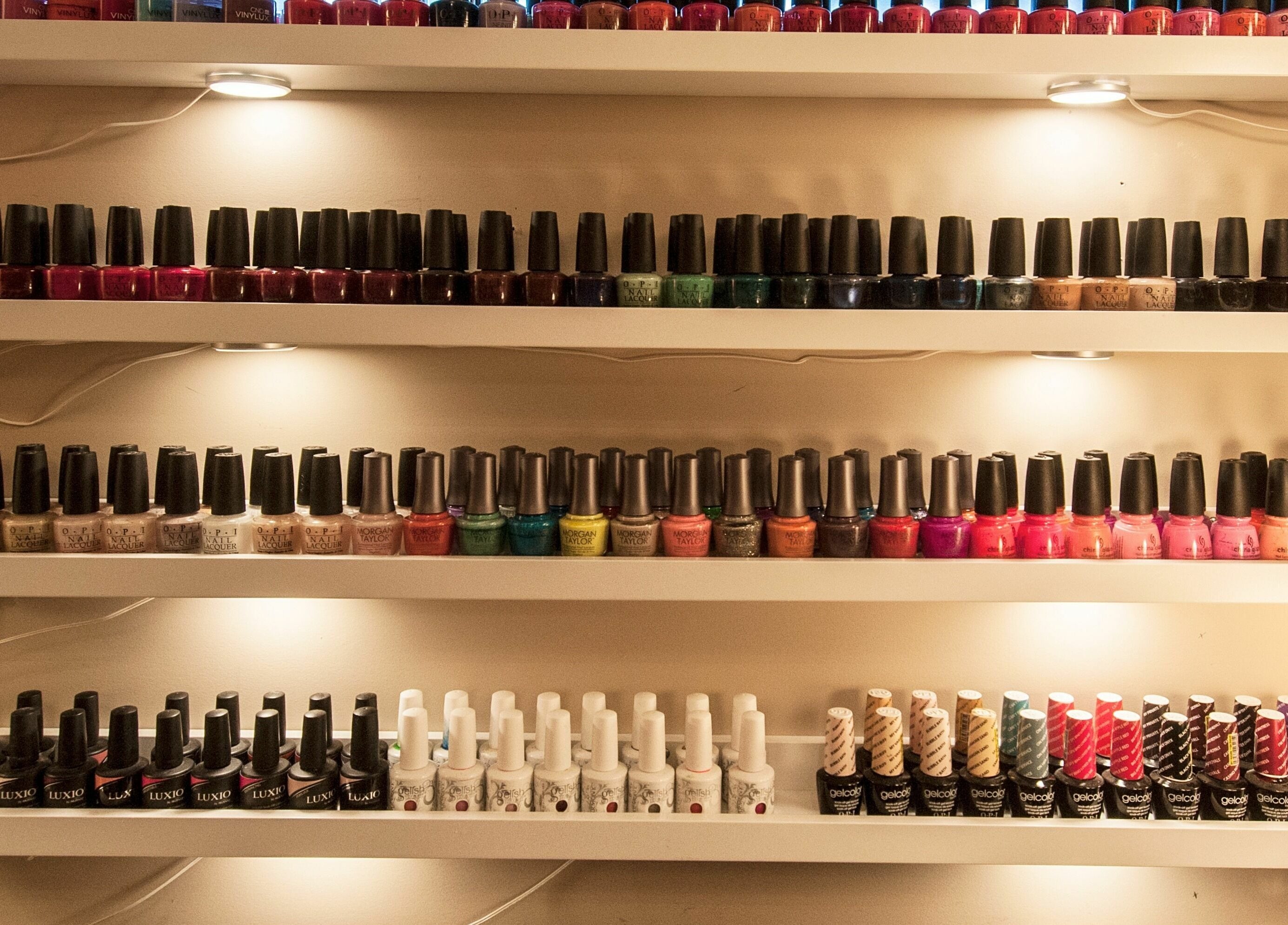 Nail polish display at Paradise Spa and Coffee Bar, East Saint Paul, Manitoba, CA. Vibrant hues line shelves.