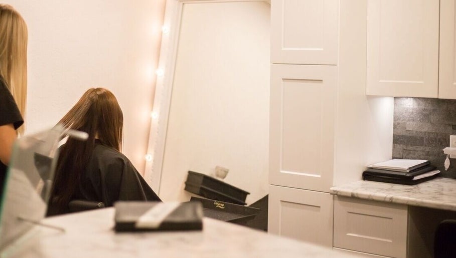 Hair styling at Paradise Spa Hair in East Saint Paul, Manitoba, CA with a chic mirror and elegant ambiance.