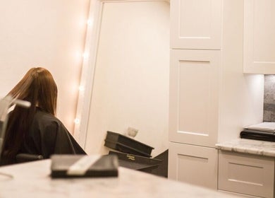 Hair styling at Paradise Spa Hair in East Saint Paul, Manitoba, CA with a chic mirror and elegant ambiance.