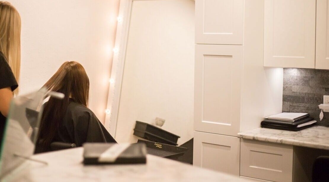 Hair styling at Paradise Spa Hair in East Saint Paul, Manitoba, CA with a chic mirror and elegant ambiance.