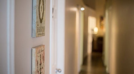 A serene hallway at Paradise Spa Hair in East Saint Paul, Manitoba, CA, adorned with elegant wall art.