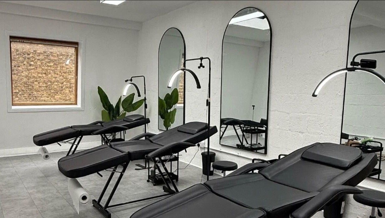 Modern treatment room with chairs at Brows_byTam in London, England, GB, featuring mirrors and plants.