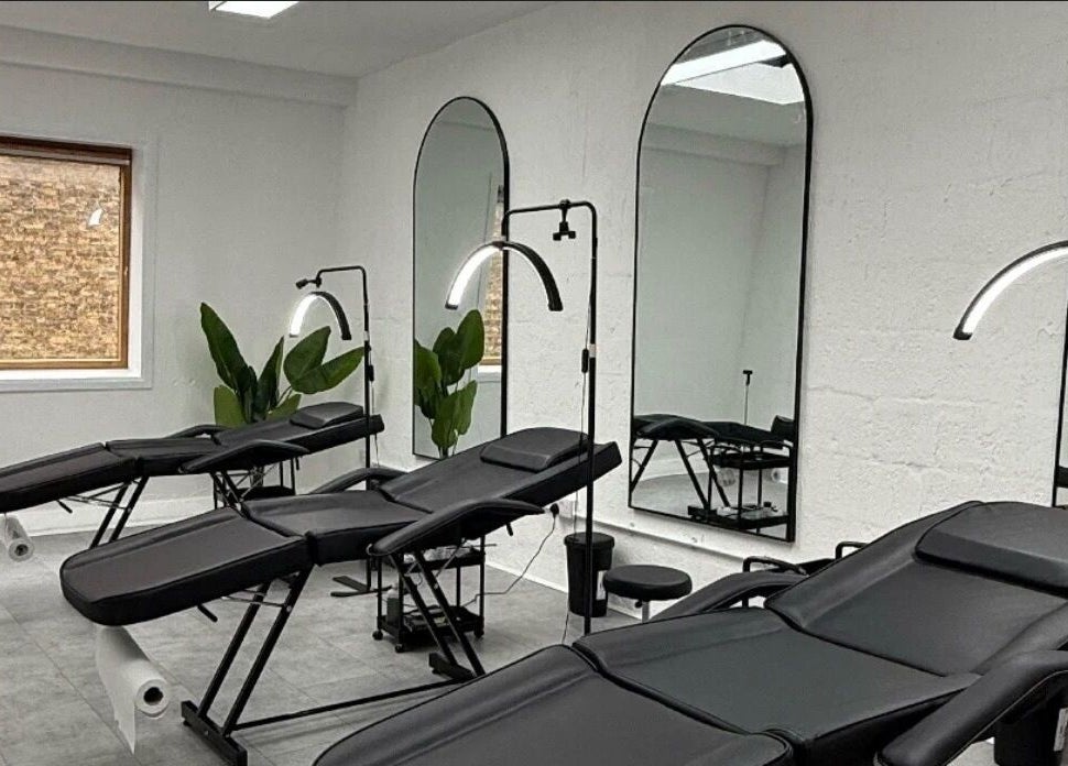 Modern treatment room with chairs at Brows_byTam in London, England, GB, featuring mirrors and plants.