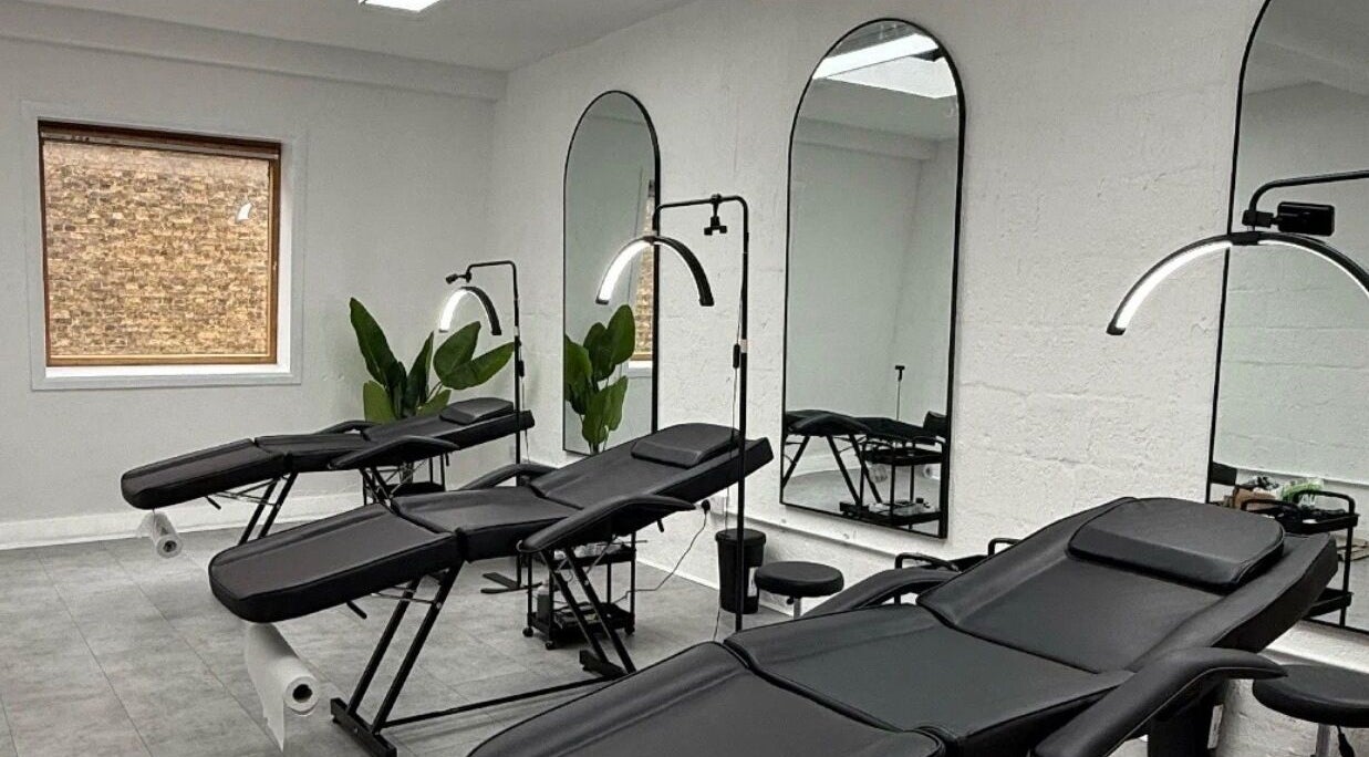 Modern treatment room with chairs at Brows_byTam in London, England, GB, featuring mirrors and plants.