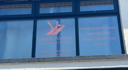 Front window of Muscle Alchemy Massage in Glengormley, Northern Ireland, GB showing services offered.