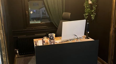 Reception desk at Muscle Alchemy Massage, Glengormley, Northern Ireland, GB, featuring a computer setup.