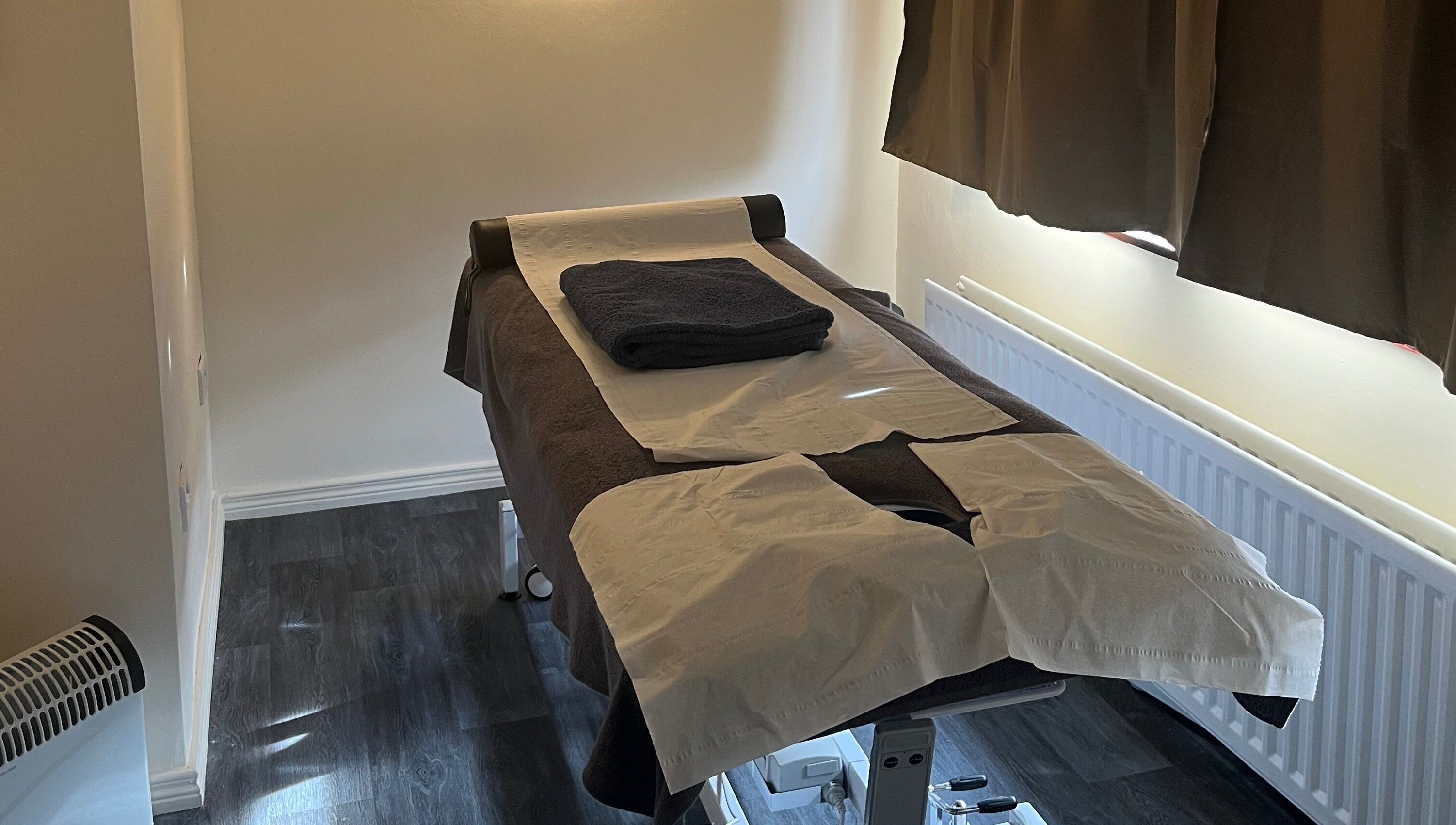 Cozy massage room at Muscle Alchemy Massage, Glengormley, Northern Ireland, GB, with prepared massage table.
