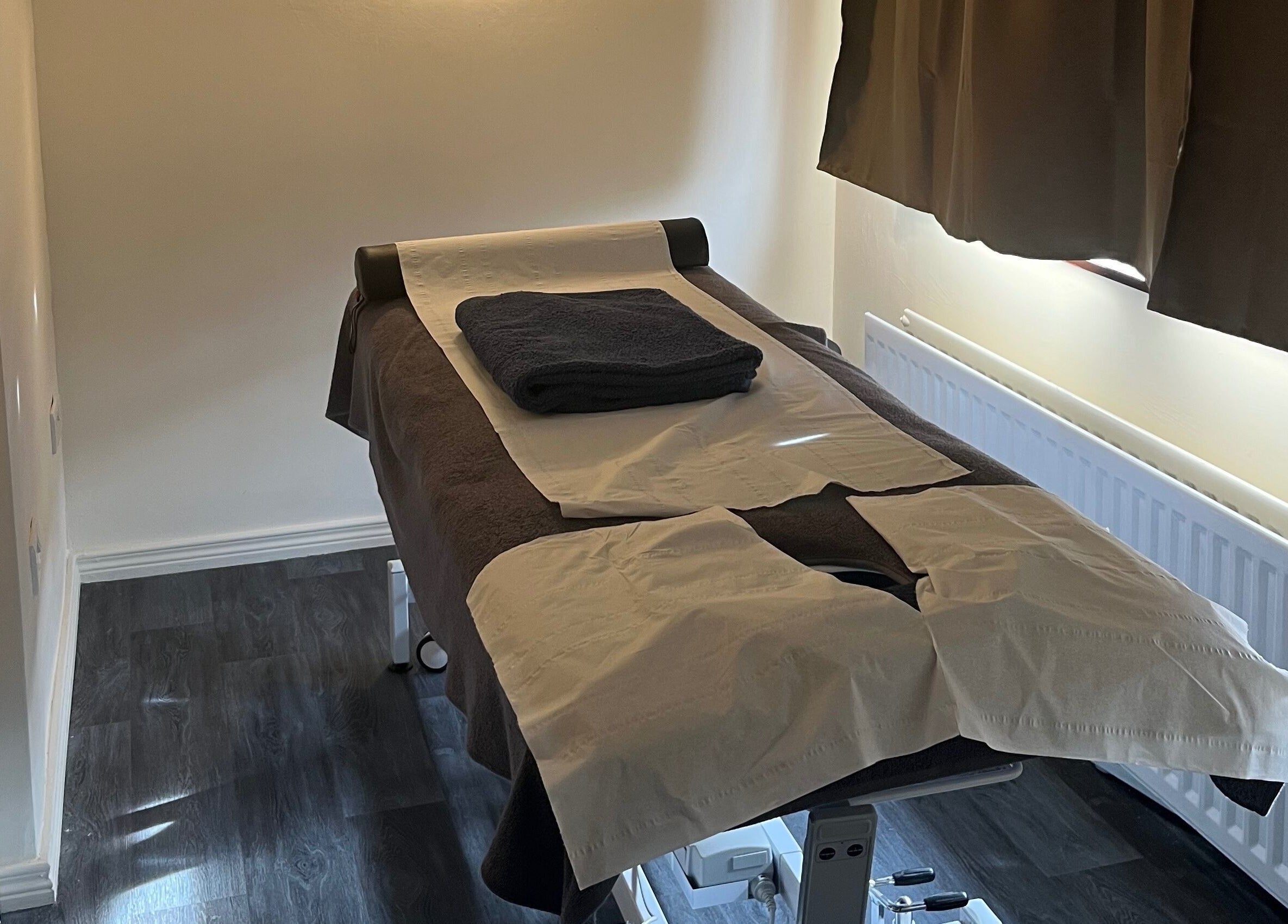 Cozy massage room at Muscle Alchemy Massage, Glengormley, Northern Ireland, GB, with prepared massage table.