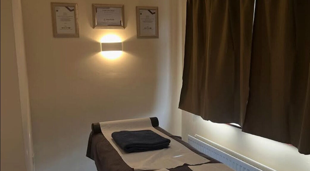 Cozy massage room at Muscle Alchemy Massage, Glengormley, Northern Ireland, GB, inviting relaxation and comfort.