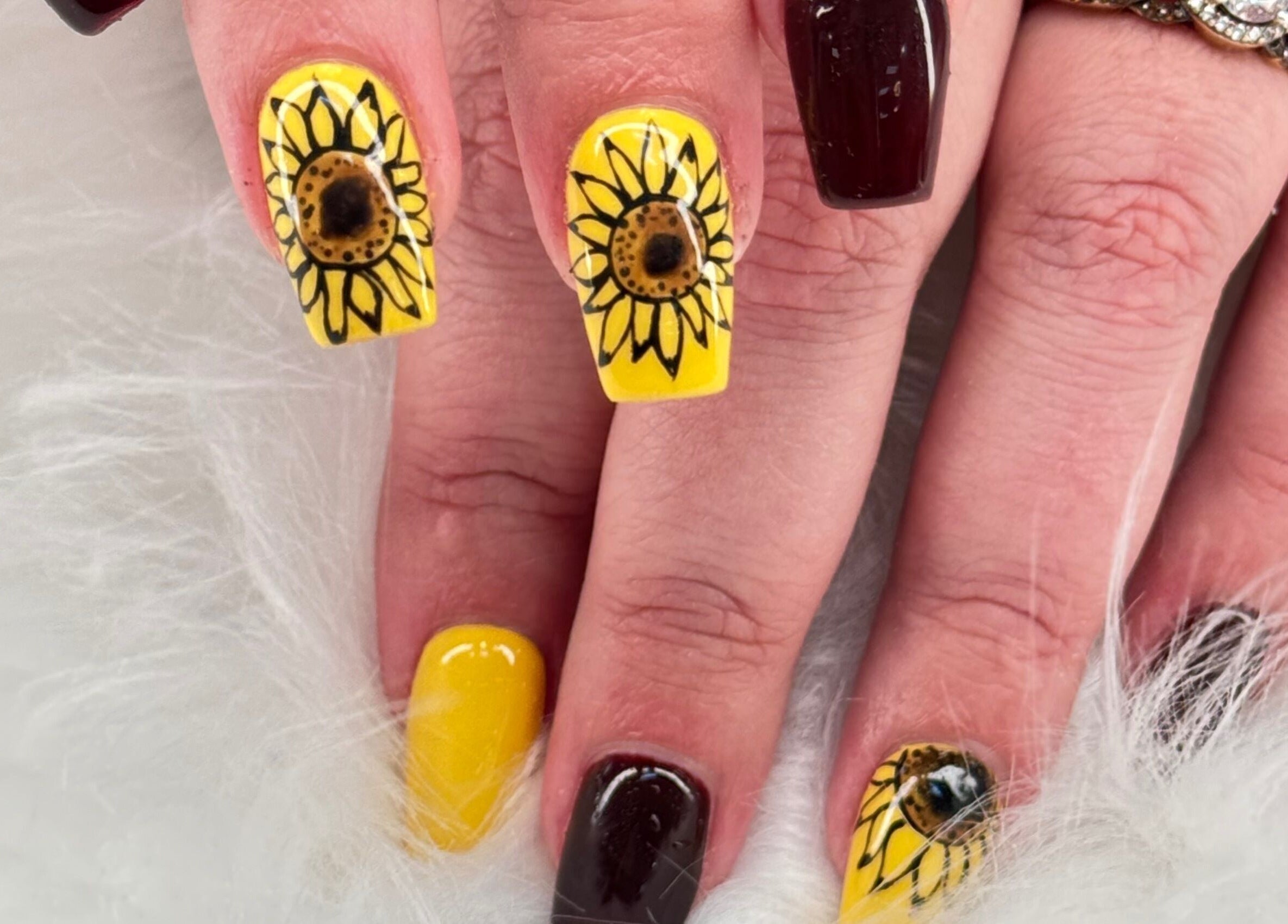 Sunflower-themed nail art at Four Seasons Nails and Spa Sherwood, Sherwood, Oregon, US.