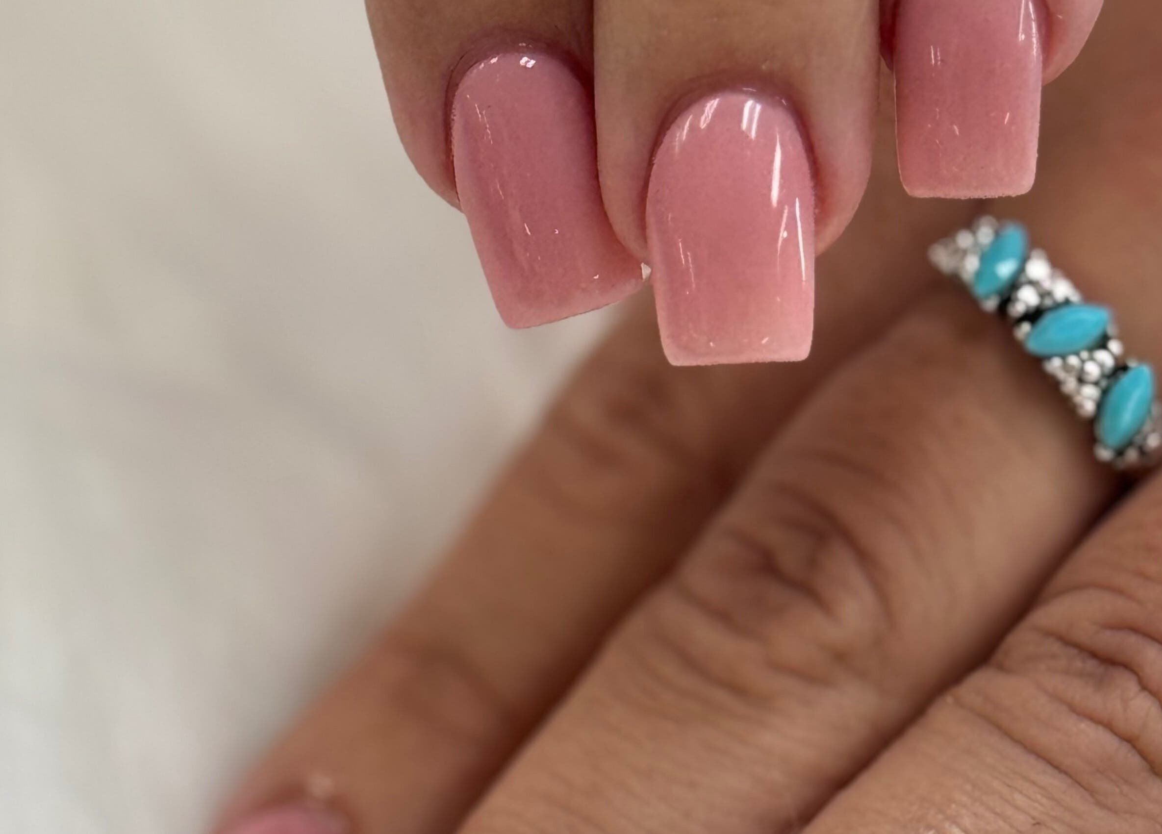 Elegant pink manicure at Four Seasons Nails and Spa Sherwood, Sherwood, Oregon, US, showcasing intricate nail art.