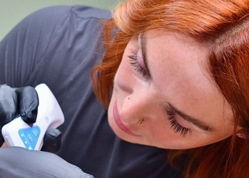 Skilled beautician at The NUE Edit @ Fine Strokes, Chadderton, Oldham, performing precise beauty treatment.