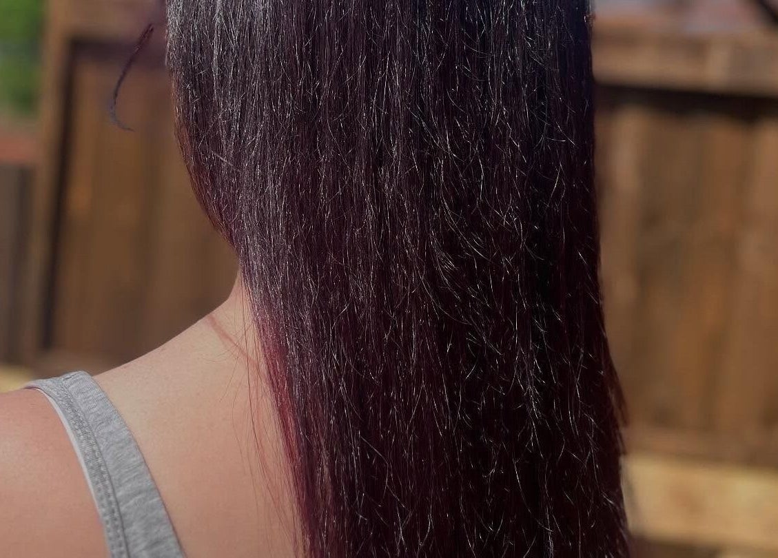 Glossy purple hair cascading down shoulders at Bendall Beauty, Farnborough, England, GB.