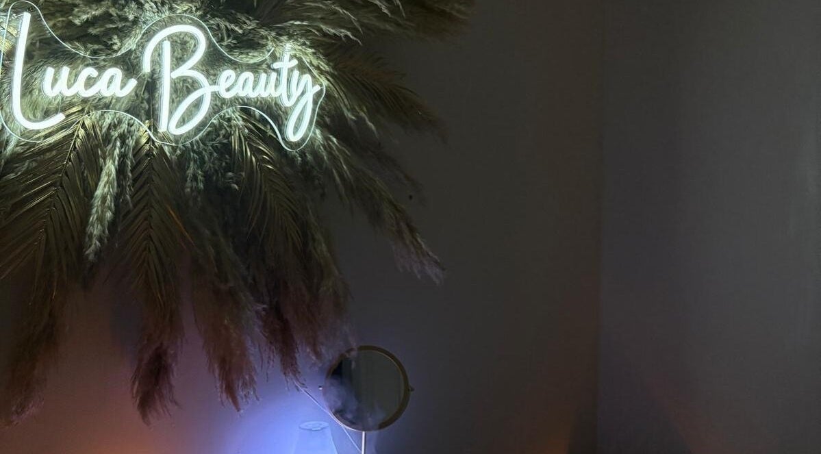 Elegant neon sign at Luca Beauty & Wellness, Cambuslang, Scotland, GB with pampas grass decor.