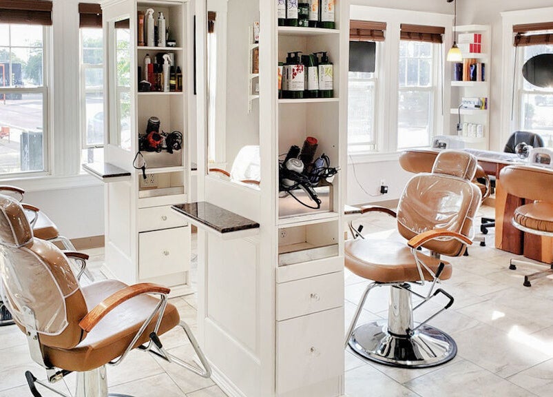 Bright salon interior at Skin Deep Skin in Quincy, Massachusetts, US, featuring modern styling chairs and equipment.