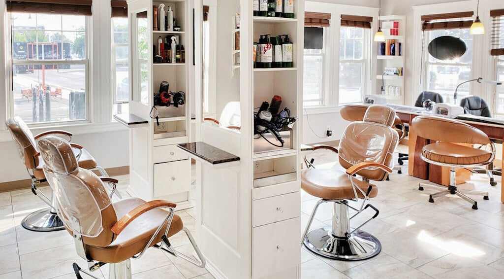 Bright salon interior at Skin Deep Skin in Quincy, Massachusetts, US, featuring modern styling chairs and equipment.