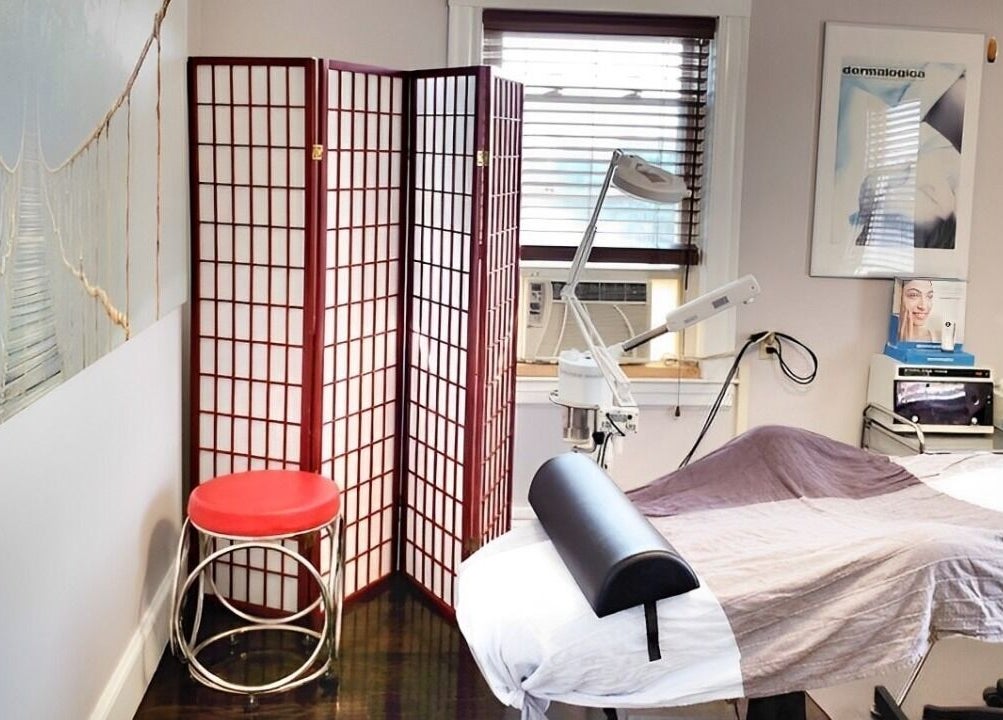 Tranquil treatment room at Skin Deep Skin in Quincy, Massachusetts, US with a bed and equipment.