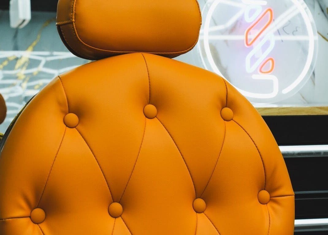 Elegant orange salon chair at SINABLENDZ ON CITY RD in Melbourne, Victoria, AU, offering comfort and style.