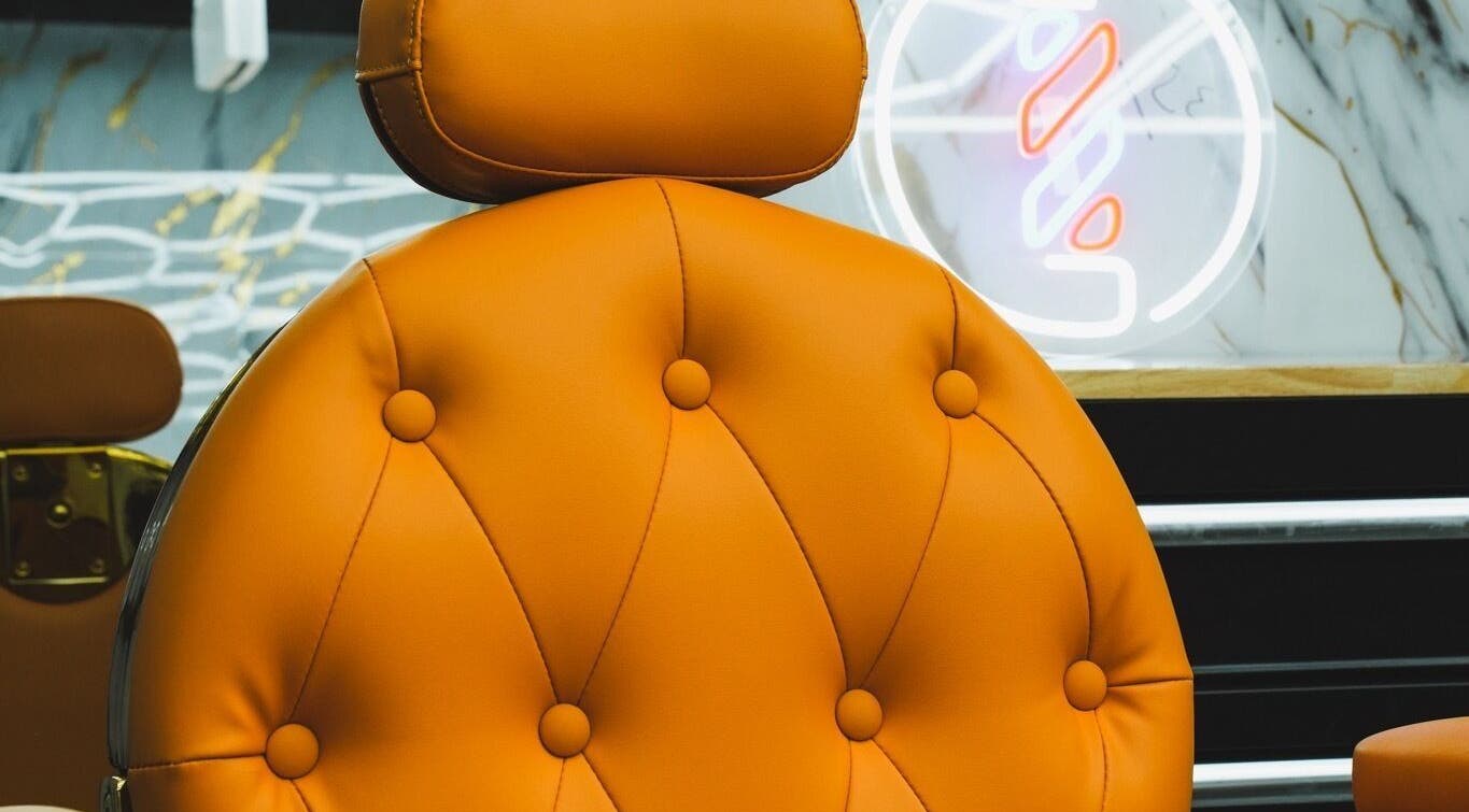 Elegant orange salon chair at SINABLENDZ ON CITY RD in Melbourne, Victoria, AU, offering comfort and style.