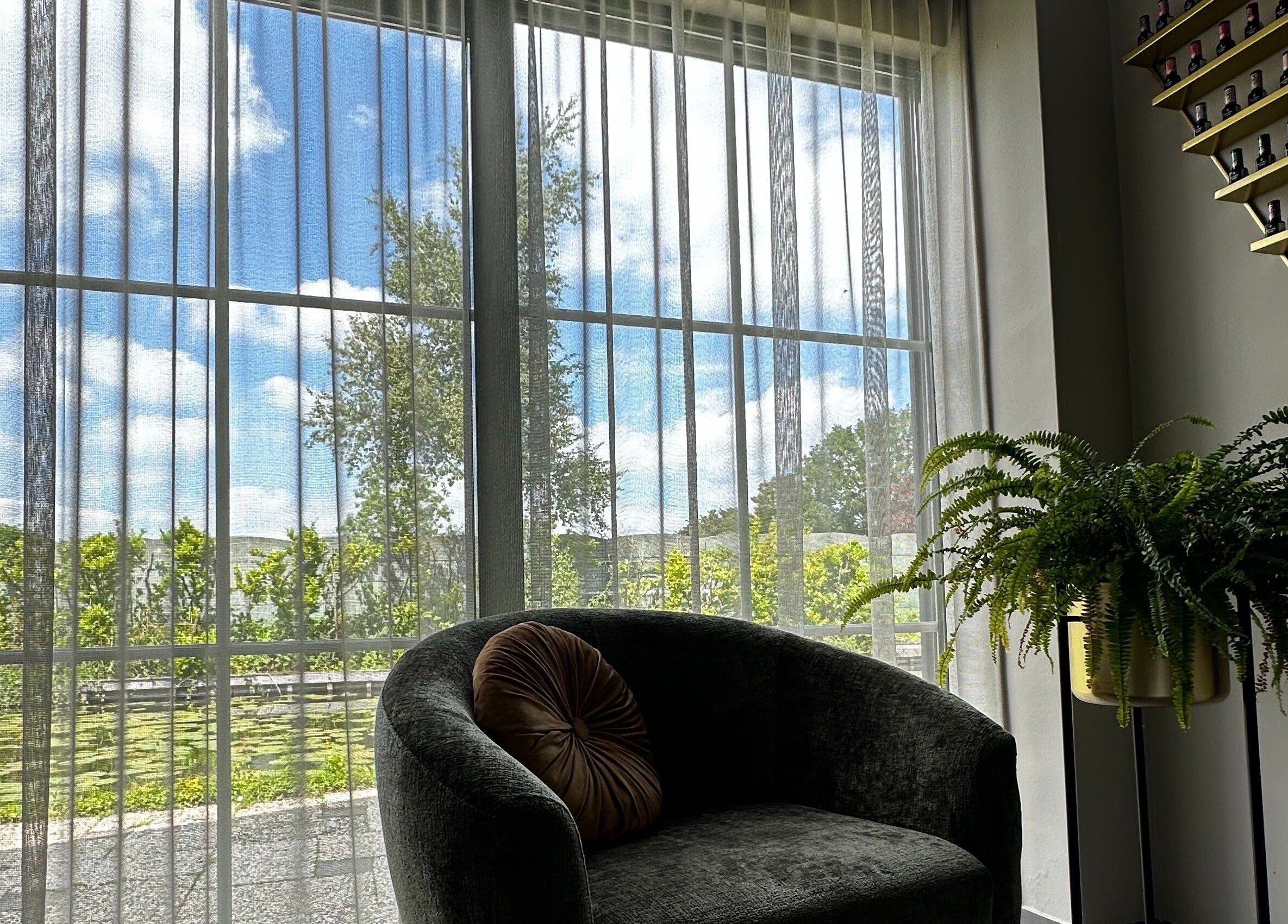 Luxe loungehoek bij Oh My Nails Studio, Maarssen, Utrecht, NL met groene plant en lichtinval.