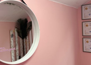 Stylish mirror on pink wall at What the Fluff! Lashes & Brows, Nottingham, England, GB.
