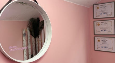 Stylish mirror on pink wall at What the Fluff! Lashes & Brows, Nottingham, England, GB.