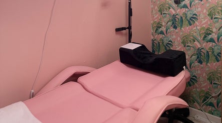 Pink beauty chair in What the Fluff! Lashes & Brows, Nottingham, England, GB, with floral wallpaper.