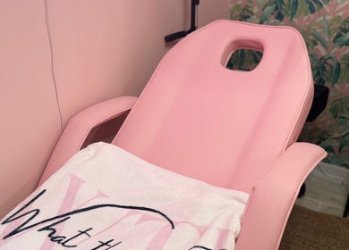 Cozy pink beauty chair at What the Fluff! Lashes & Brows in Nottingham, England, GB, featuring a plush towel.
