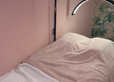 Relaxing treatment bed at What the Fluff! Lashes & Brows, Nottingham, England, GB, with soft pink blanket.