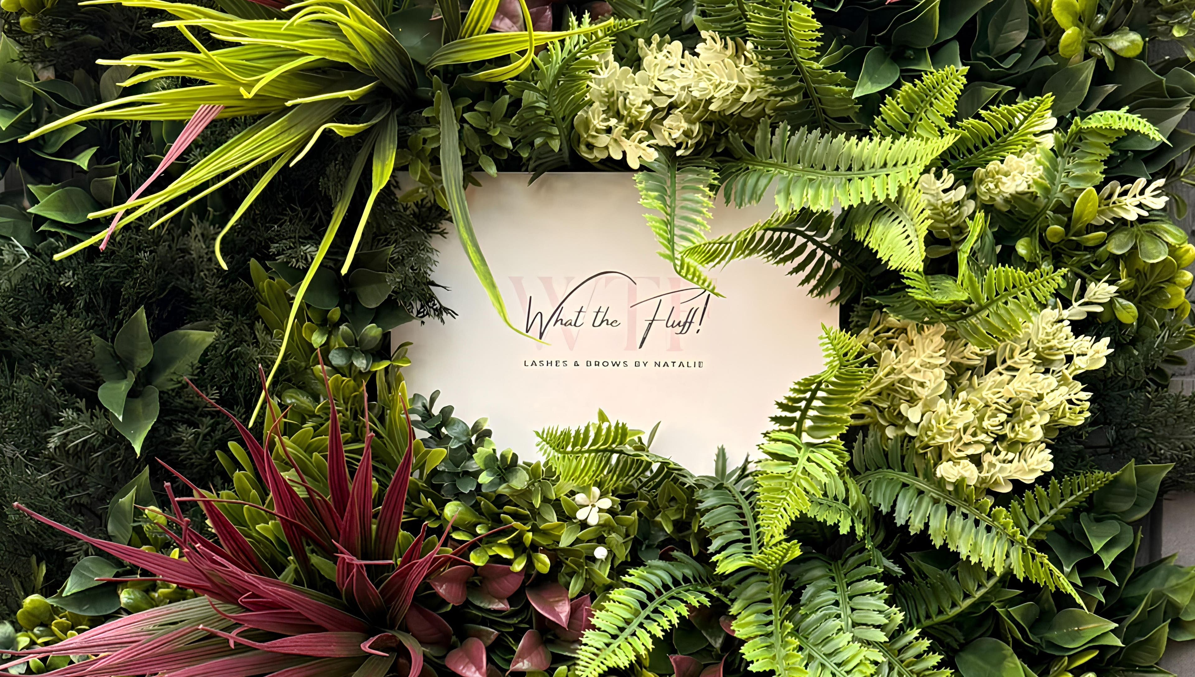 Floral display with 'What the Fluff! Lashes & Brows' sign in Nottingham, England, GB.