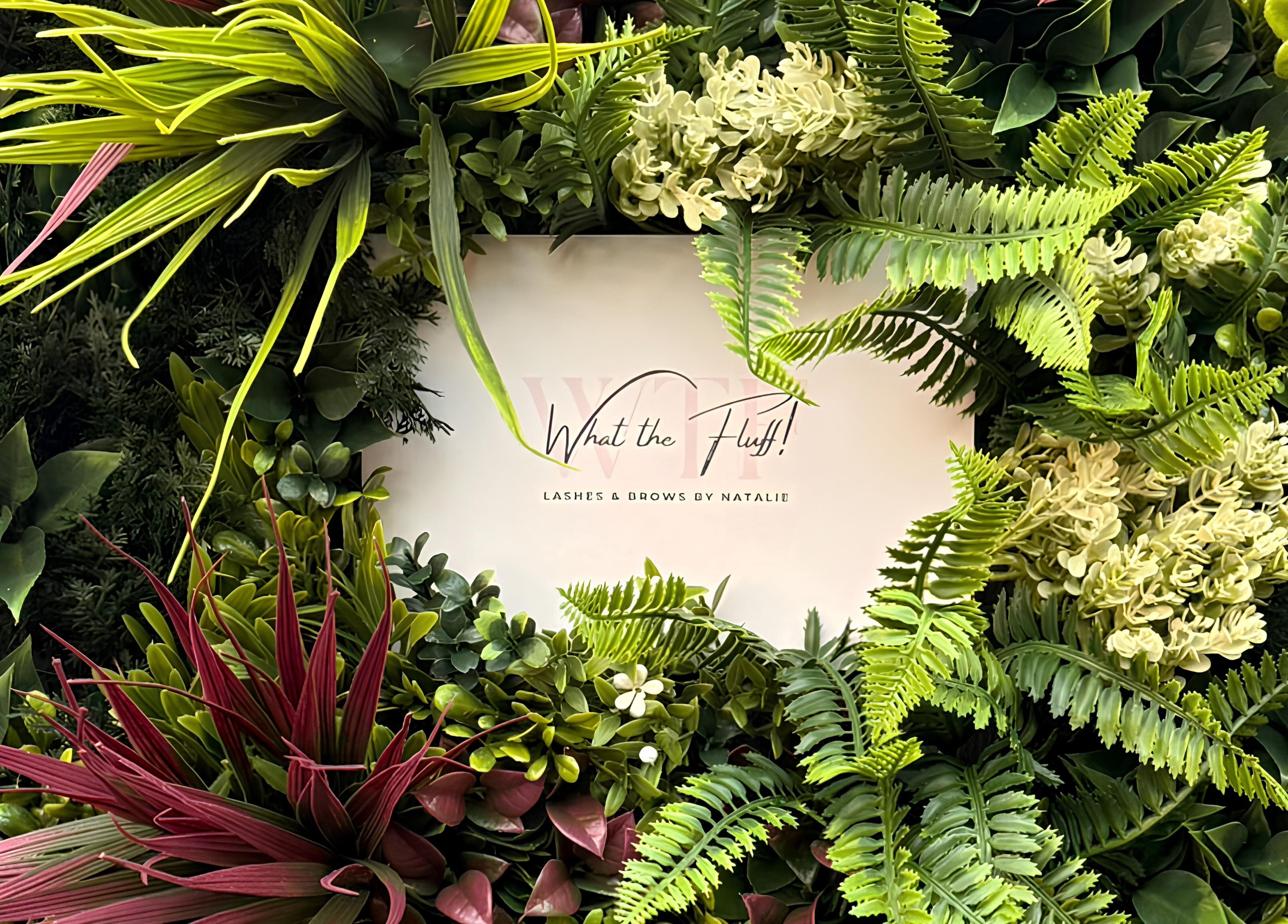 Floral display with 'What the Fluff! Lashes & Brows' sign in Nottingham, England, GB.